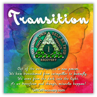 1 year AA medallion, emerald green with 21 genuine green crystals ranging from light to dark green in the shape of the triangle in the center, to thine own self be true, number, unity, service recovery is in embossed 14k gold plated brass, sealed in resin and is on a bold tie-dye 3x3 card with a butterfly silhouette and transition at the top and paragraph below emphasizing the transformation of the recovery journey.