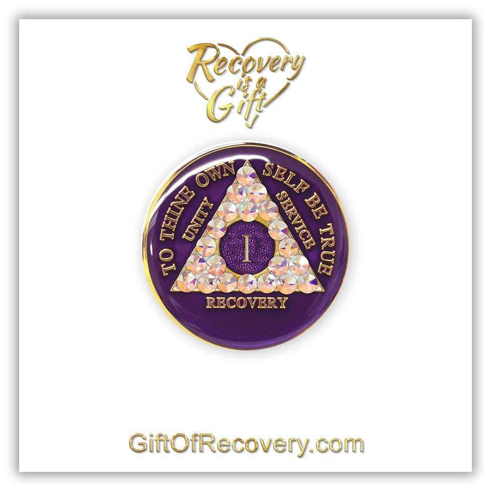 1 year AA medallion Purple Amethyst adorned with 21 Aurora Borealis Genuine crystals for the triangle, to thine own self be true, unity, service, recovery along with roman numeral are embossed with 14k gold-plated brass, recovery medallion is sealed with resin for a shiny finish that will last, featured on a white 3x3 card with recovery is a gift and giftofrecovery.com in the color gold.