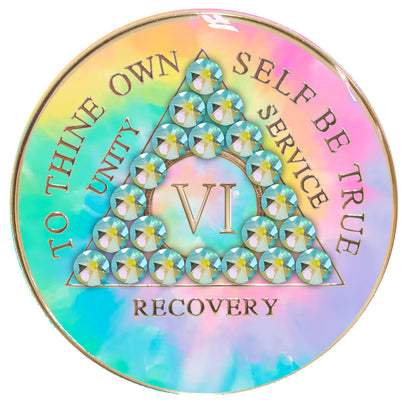 6 year AA medallion pastel tie-dye representing a psychic change that is needed in the recovery journey, with twenty-one Peridot AB genuine crystals, pink, blue, yellow, and green, in the shape of the triangle, with the AA moto and roman numeral embossed in 14k gold-plated brass, the medallion is sealed with resin for a glossy, scratch free finish.