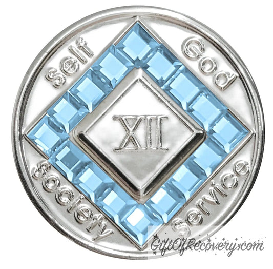 12 year nickel plated NA medallion with self, God, Society, and Service around the outer rim of the diamond, 16 square  Aquamarine CZ genuine crystals that form the diamond around the roman numeral.