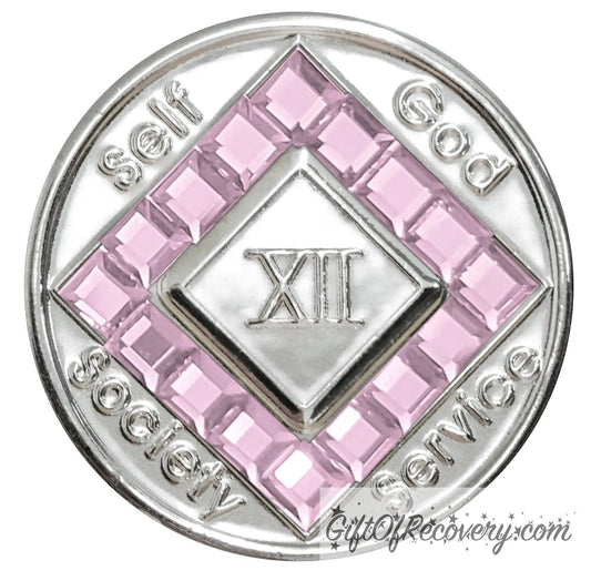 12 year nickel plated NA medallion with self, God, Society, and Service around the outer rim of the diamond, 16 square light rose CZ genuine crystals that form the diamond around the roman numeral.