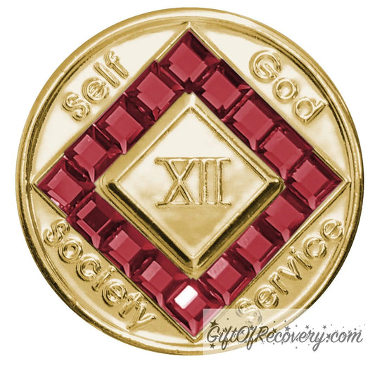 12 year gold plated NA medallion with self, God, Society, and Service around the outer rim of the diamond, 16 square Scarlet red CZ genuine crystals that form the diamond around the roman numeral.