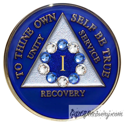 1 Year Big Book Blue AA medallion with 5 blue genuine crystals and 5 clear genuine crystal, making a circle around the 1 year, the recovery medallion has raised lettering to thine own self be true, and the outer rim of the medallion in 14k gold, inside the triangle is white and blue, emphasizing action and reflection.