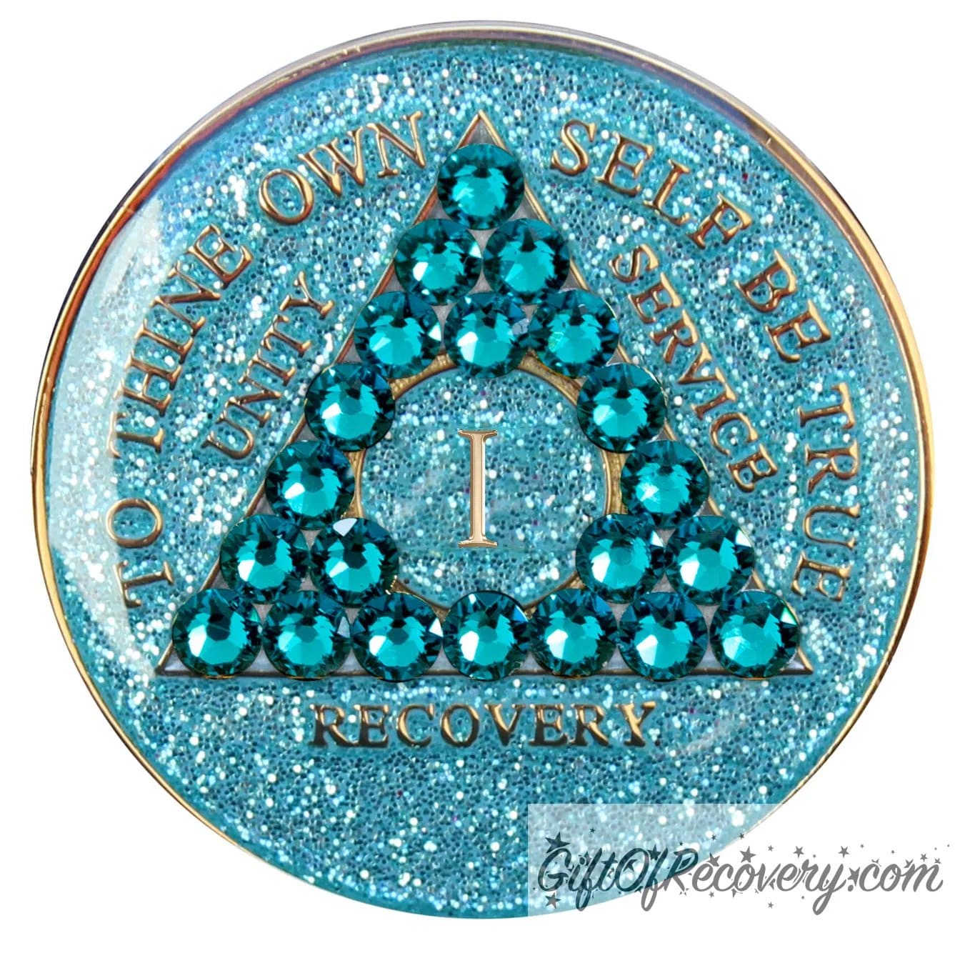 1 year AA medallion in aqua glitter with to thine own self be true, unity, service, recovery, the roman numeral in the center, and the outer rim of the medallion embossed in 14k gold plated brass, the center triangle has 21 genuine blue zircon crystal to give it a sparkle, it is sealed with resin for a shiny finish. 