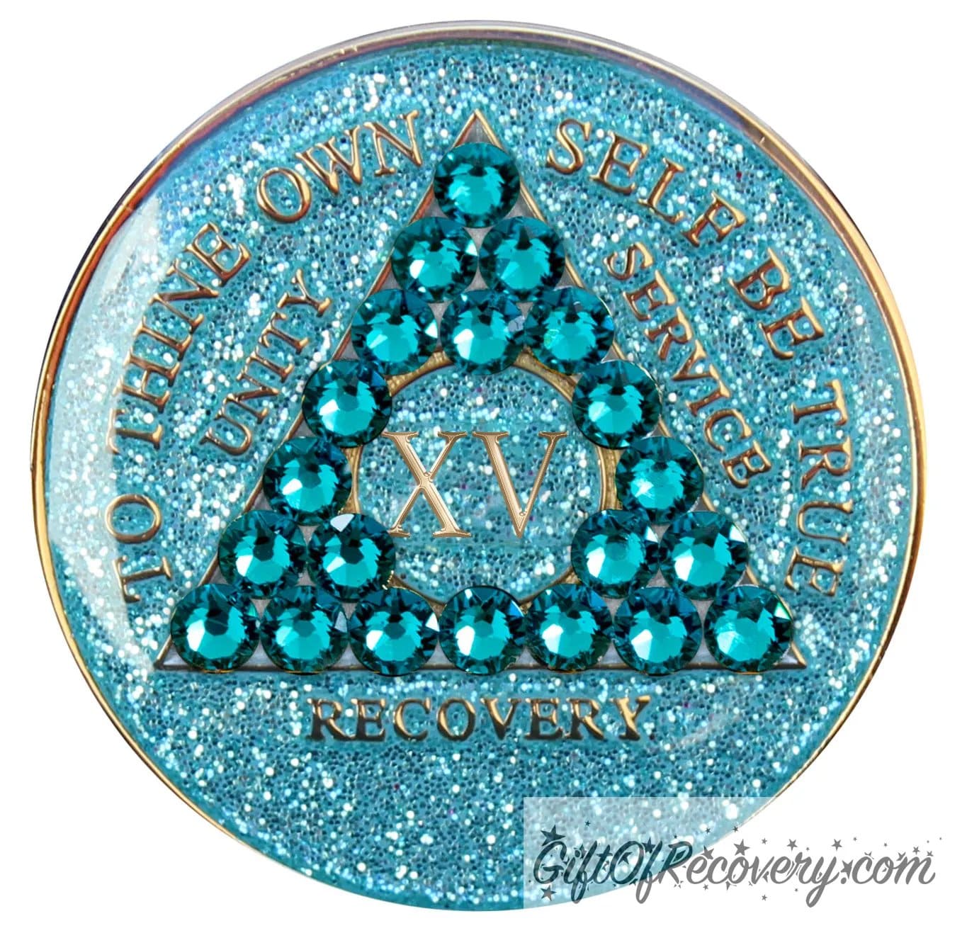 15 year AA medallion in aqua glitter with to thine own self be true, unity, service, recovery, the roman numeral in the center, and the outer rim of the medallion embossed in 14k gold plated brass, the center triangle has 21 genuine blue zircon crystal to give it a sparkle, it is sealed with resin for a shiny finish.