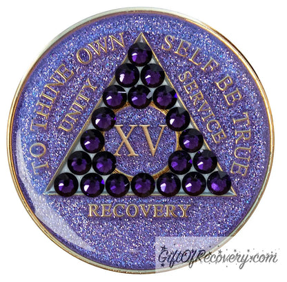 15 year glitter purple AA medallion with 21 purple velvet genuine crystals, that create the triangle in middle, and to thine own self be true, unity, service, recovery, the roman numeral in the center of the circle triangle, along with the rim of the recovery medallion, are embossed in 14 gold plated brass, sealed in resin for glossy finish.