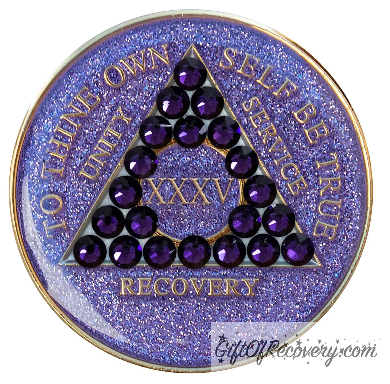 35 year glitter purple AA medallion with 21 purple velvet genuine crystals, that create the triangle in middle, and to thine own self be true, unity, service, recovery, the roman numeral in the center of the circle triangle, along with the rim of the recovery medallion, are embossed in 14 gold plated brass, sealed in resin for glossy finish.