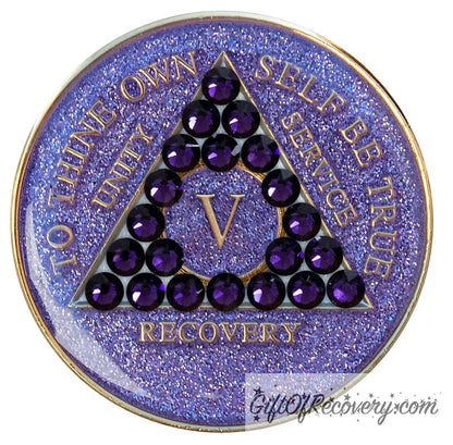 5 year glitter purple AA medallion with 21 purple velvet genuine crystals, that create the triangle in middle, and to thine own self be true, unity, service, recovery, the roman numeral in the center of the circle triangle, along with the rim of the recovery medallion, are embossed in 14 gold plated brass, sealed in resin for glossy finish.