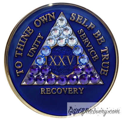 25 year Big Book Blue AA medallion with 21 genuine crystals forming the triangle, going from light to dark blue to represent transitions in your recovery journey, the center circle is blue sparkle, with the roman numeral, AA moto and rim in 14k gold plated brass and resin sealed for a glossy finish.