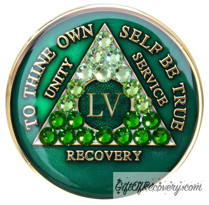 55 year AA medallion, emerald green with 21 genuine green crystals ranging from light to dark green in the shape of the triangle in the center to emphasize the transformation in the recovery journey, to thine own self be true, roman number, unity, service recovery are embossed in 14k gold-plated brass, the middle circle is sparkle green and the recovery medallion is sealed in resin for a shiny finish that lasts.