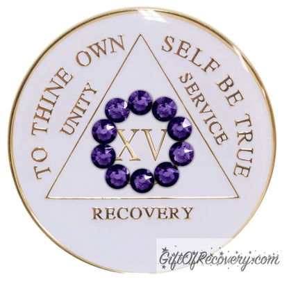 15 year AA medallion in pearl white with ten genuine purple velvet crystal in a circle representing our common welfare and personal recovery, to thine own self be true and other AA moto embossed with 14k gold-plated brass, the recovery medallion is sealed with resin for a scratch free shiny finish.