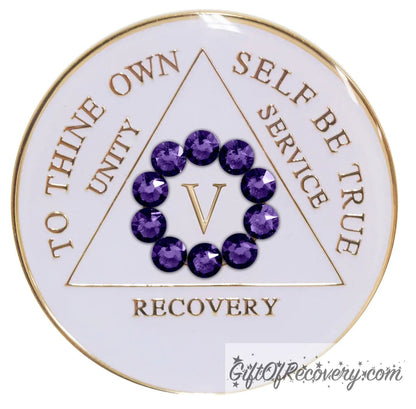 5 year AA medallion in pearl white with ten genuine purple velvet crystal in a circle representing our common welfare and personal recovery, to thine own self be true and other AA moto embossed with 14k gold-plated brass, the recovery medallion is sealed with resin for a scratch free shiny finish.