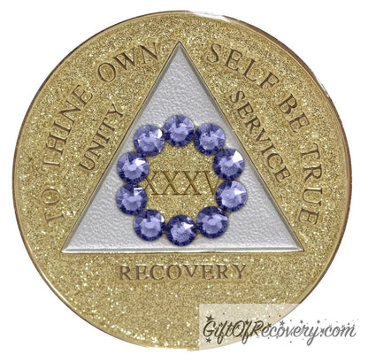 35 year AA medallion gold glitter with ten genuine purple crystal in the shape of a circle around the roman numeral to symbolize our common welfare and personal recovery, and the triangle soft silver, to thine own self be true, unity, service. recovery are embossed with 14k gold-plated brass the recovery medallion is sealed with resin for a scratch free shiny finish.