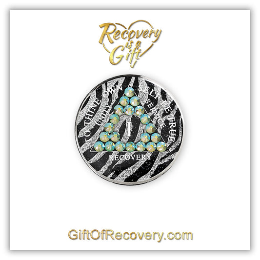 1 year Zebra style AA medallion with 21 genuine peridot crystals, AA moto, unity, service, recovery, and roman numeral are in white and blend into the pattern, so you can let your recovery shine, not your time, the outer rim is silver plated, sealed in a high-quality, chip and scratch-resistant resin dome giving it a beautiful glossy look that will last, recovery medallion is featured on a 3x3 white card, with Recovery is a Gift top center and giftofrecovery.com bottom center, both are in the color gold. 