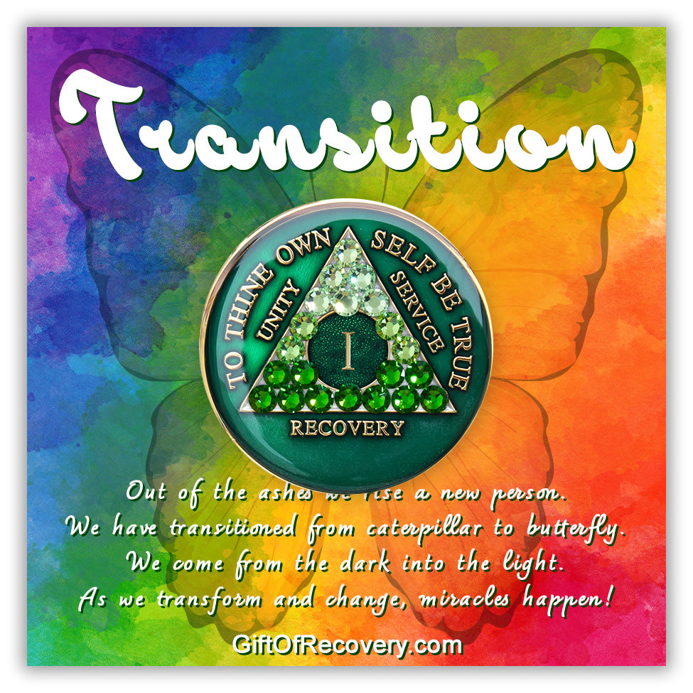 1 year AA medallion, emerald green with 21 genuine green crystals ranging from light to dark green in the shape of the triangle in the center, to thine own self be true, number, unity, service recovery is in embossed 14k gold plated brass, sealed in resin and is on a bold tie-dye 3x3 card with a butterfly silhouette and transition at the top and paragraph below emphasizing the transformation of the recovery journey.