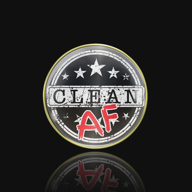 Clean AF NA medallion with Clean in black on a white rectangle strip, and the AF in bold red, there are 10 white stars, 5 above sober and 5 below, there are 2 white circles near the 14k rim for outline. The recovery medallion is in a black frame and spinning slowly for an accurate depiction of the medallion.