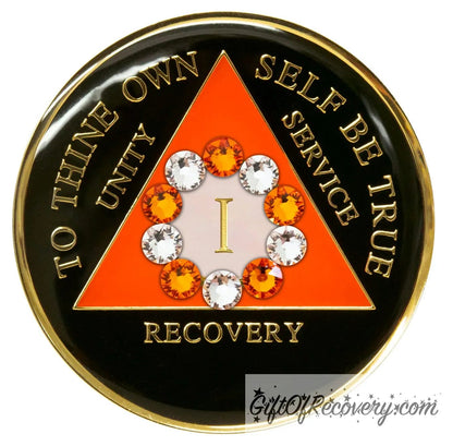 1 Year Sunset orange and black 10th step AA medallion with 5 orange genuine crystals and 5 clear genuine crystal, formed in a circle around the year, to thine own self be true, triangle in the center and unity, service, recovery, along with rim of medallion are slightly raised in 14k gold, the center of the triangle is sunset orange with the circle being white, all emphasizing action and reflection.
