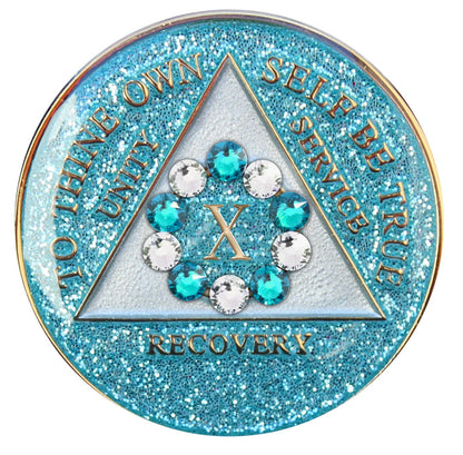 10 Year Deep-sea Aqua glitter 10th step AA medallion with 5 blue genuine crystals and 5 clear genuine crystal, formed in a circle around the year, to thine own self be true, triangle in the center and unity, service, recovery, along with rim of medallion are slightly raised in 14k gold, the center of the triangle is pearl white with the circle being aqua glitter, all emphasizing action and reflection.