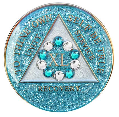 40 Year Deep-sea Aqua glitter 10th step AA medallion with 5 blue genuine crystals and 5 clear genuine crystal, formed in a circle around the year, to thine own self be true, triangle in the center and unity, service, recovery, along with rim of medallion are slightly raised in 14k gold, the center of the triangle is pearl white with the circle being aqua glitter, all emphasizing action and reflection.