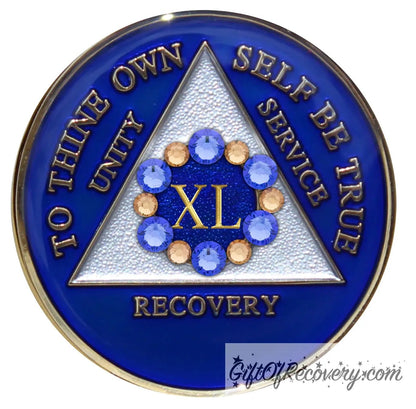 40 year AA medallion Big Book blue with 6 genuine blue crystals and 6 gold in a circle around the roman numeral like a flower symbolizing the 12 steps and growth in recovery, the triangle is pearl white, AA slogan and three legacies are embossed 14k gold-plated brass, sealed with resin for a shiny finish.