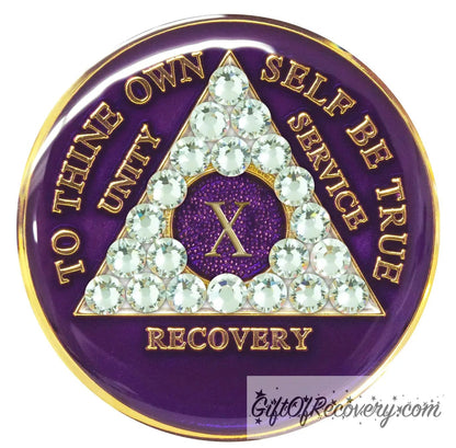 10 year AA medallion purple amethyst, adorned with 21 genuine diamond CZ crystals to represent transformation under pressure in the recovery journey, to thine own self be true, unity, service, recovery embossed with 14k gold-plated brass and sealed with resin for a glossy finish that is scratch proof and will last.