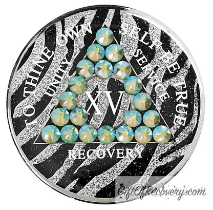 15 year Zebra glitter style AA medallion with 21 genuine peridot crystals, AA moto, unity, service, recovery, and roman numeral are in white and blend into the pattern, so you can let your recovery shine, not your time, the outer rim is silver plated, sealed in a high-quality, chip and scratch-resistant resin dome giving it a beautiful glossy look that will last.
