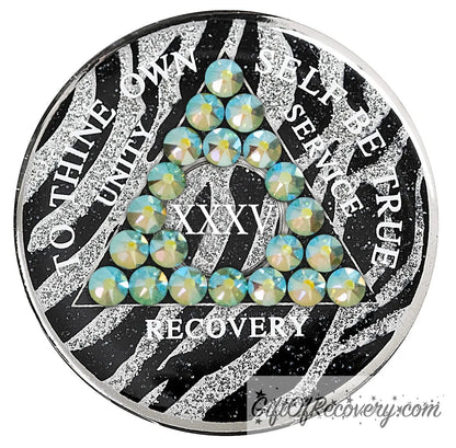 35 year Zebra glitter style AA medallion with 21 genuine peridot crystals, AA moto, unity, service, recovery, and roman numeral are in white and blend into the pattern, so you can let your recovery shine, not your time, the outer rim is silver plated, sealed in a high-quality, chip and scratch-resistant resin dome giving it a beautiful glossy look that will last.