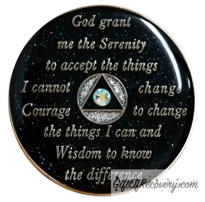 Back of zebra glitter AA recovery medallion is black glitter onyx and has the serenity prayer, outer rim, and the circle triangle in the center silver-plated brass, the circle is silver glitter and triangle is black with one single peridot AB genuine crystal in the center of the triangle, the recovery medallion is sealed with resin for a shiny finish. 