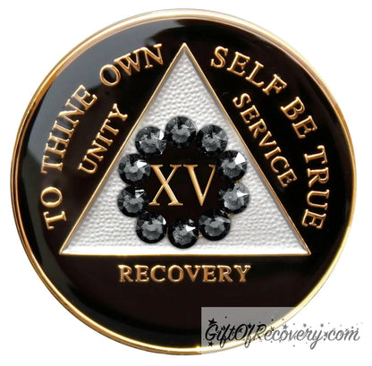 15 Year AA medallion black onyx with white triangle and 10 genuine black crystals around the number to symbolize our unity in the program, AA moto and 3 legacies are embossed with 14k gold-plated brass and it is sealed with resin for a glossy finish.