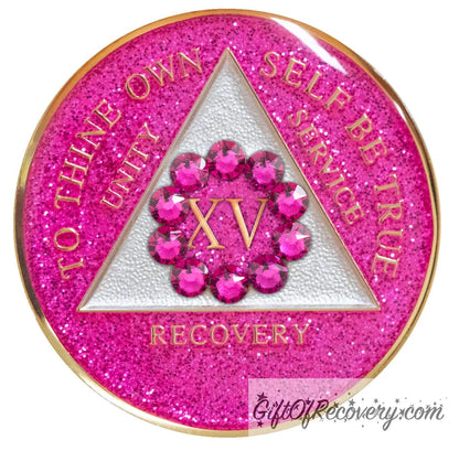 15 year AA medallion Pink Glitter Princess adorned with 10 pink zircon genuine crystals in a circle around the roman numeral, representing the unity that binds us, the triangle is pearl white and the AA moto is embossed with 14k gold-plated brass, sealed with resin for a shiny finish that will last and is scratch proof.