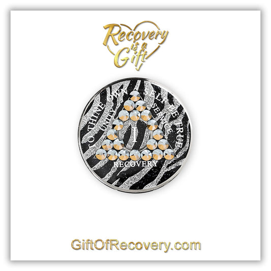 1 Year zebra glitter print AA medallion with 21 genuine comet crystals in a triangle around the year, the lettering unity, service, recovery, the 1 year and To Thine Own Self Be True are in white and the recovery medallion is placed on a white 3x3 card with the web address and recovery is a gift logo in the color gold. 